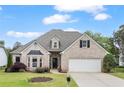 Charming single-Gathering home with a well-manicured lawn and attached two-car garage at 5375 Glenhaven Dr, Cumming, GA 30041
