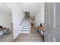 Bright foyer features wood-look floors, staircase, a mirror and decorative console table at 1624 Gunnin Nw Trce, Atlanta, GA 30318