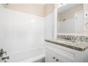 Clean bathroom with white tile, updated vanity with granite countertop, and modern fixtures at 2771 Dresden Trl, Atlanta, GA 30344