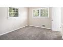 Cozy bedroom with carpeted floors, neutral walls, and natural light from the large windows at 2771 Dresden Trl, Atlanta, GA 30344