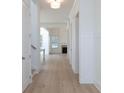 Bright hallway with hardwood floors leading to living area with fireplace at 5623 Meadowstone Walk, Kennesaw, GA 30152