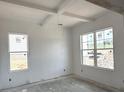 Bright living room featuring white walls and trim, complemented by windows and natural light at 5623 Meadowstone Walk, Kennesaw, GA 30152