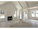 Bright living room featuring a fireplace, white walls, and natural light from large windows at 5623 Meadowstone Walk, Kennesaw, GA 30152