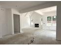 Spacious living room with a fireplace, high ceilings, and large windows offering views at 5623 Meadowstone Walk, Kennesaw, GA 30152
