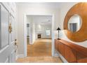 Inviting foyer featuring hardwood floors and a view into the living room with a fireplace at 211 Colonial Homes Nw Dr # 1105, Atlanta, GA 30309