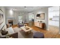 Bright living room with hardwood floors, a fireplace, and access to the kitchen and dining area at 211 Colonial Homes Nw Dr # 1105, Atlanta, GA 30309