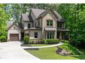 Charming two-story home with a manicured lawn, beautiful landscaping, and a two-car garage at 610 Valley Green Trce, Marietta, GA 30068