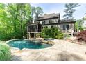 Backyard pool with stone patio, screened porch, and surrounding landscaping. A great outdoor entertaining area! at 610 Valley Green Trce, Marietta, GA 30068