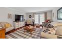 Bright living room with hardwood floors, a flat screen, and lots of seating at 3440 Essex Ave # 103, Atlanta, GA 30339