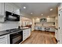 Well-lit kitchen featuring granite countertops, and dual built-in office desks at 443 Lakeshore Dr, Berkeley Lake, GA 30096
