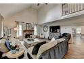 Inviting living room with high ceilings, stone fireplace, and comfortable seating arrangement at 443 Lakeshore Dr, Berkeley Lake, GA 30096