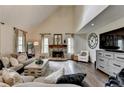Cozy living room with a stone fireplace, hardwood floors, and neutral decor at 443 Lakeshore Dr, Berkeley Lake, GA 30096