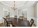 Spacious dining room featuring hardwood floors, crown molding, and elegant chandelier at 172 Mill Creek Dr, Canton, GA 30115