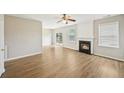Inviting living room boasts a cozy fireplace, ceiling fan, and natural light at 172 Mill Creek Dr, Canton, GA 30115