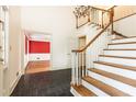 Foyer with hardwood staircase, tile flooring, and view into a living space at 295 Glen Lake Dr, Atlanta, GA 30327