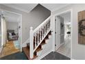 Welcoming entryway features hardwood stairs with white railing, with entrances to other rooms at 411 Woodstone West Dr, Marietta, GA 30068