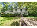 Charming two-story home with black shutters and a well-manicured front yard at 411 Woodstone West Dr, Marietta, GA 30068