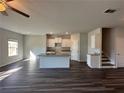 Bright open concept featuring wood flooring, granite countertops and a seamless flow into living spaces at 8656 Webb Rd, Riverdale, GA 30274