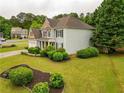 Lovely home with manicured shrubs and a green lawn at 120 Clifford Ct, Canton, GA 30115