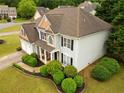 Beautiful two-story home featuring lush landscaping and a well-maintained lawn at 120 Clifford Ct, Canton, GA 30115