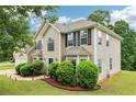 Exterior shot of a home with a two-car garage and manicured landscaping at 4015 Soaring Dr, Douglasville, GA 30135