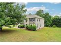 Well-maintained two-story home with a manicured lawn and mature trees at 4015 Soaring Dr, Douglasville, GA 30135