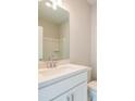 Modern bathroom features a white vanity, a white countertop, and chrome fixtures at 1907 Deco Dr, Kennesaw, GA 30144