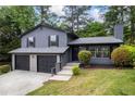 Charming two-story home with a two-car garage, landscaped front yard, and chimney at 2246 Hightrail Ct, Lithonia, GA 30058