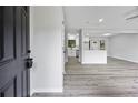 Bright living room with new gray flooring and view of kitchen at 2246 Hightrail Ct, Lithonia, GA 30058