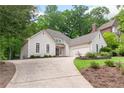 Home with an expansive driveway, attached two-car garage, and meticulously maintained front lawn at 2140 Azalea Dr, Roswell, GA 30075