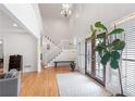 Bright foyer featuring hardwood floors, a staircase to the second story, and a modern chandelier at 2140 Azalea Dr, Roswell, GA 30075