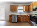 Kitchen featuring wood cabinets, stainless steel appliances, and stylish vinyl flooring at 67 Jennifer Ln, Rydal, GA 30171