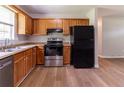 A well-lit kitchen featuring wood cabinets, stainless steel appliances, and modern wood-look flooring at 67 Jennifer Ln, Rydal, GA 30171
