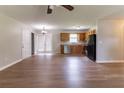 Open-concept living and kitchen area with wood floors and natural light from the sliding glass doors at 67 Jennifer Ln, Rydal, GA 30171