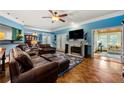 Spacious living room with hardwood floors, fireplace, and open doorway to a sunroom at 1703 Brandywine Ct, Atlanta, GA 30338