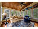 Bright sun room with wood ceilings, large windows, and comfortable seating area at 1703 Brandywine Ct, Atlanta, GA 30338