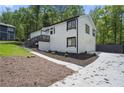 Well-kept exterior featuring a driveway, a stylish garage, and landscaped greenery at 1819 Laurel Ridge Sw Dr, Conyers, GA 30094