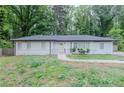 Charming white-painted home with a well-maintained front yard and welcoming yellow front door at 2174 Beecher Sw Rd, Atlanta, GA 30311