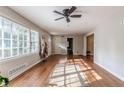 Sun-drenched living room with beautiful hardwood floors and a view of the front yard through large windows at 2174 Beecher Sw Rd, Atlanta, GA 30311
