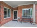 Welcoming front porch features brick accents, a bench, and an inviting entrance at 803 Brookhavenrun Cir, Duluth, GA 30097