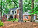 Charming brick home with mature trees, black shutters and a beautifully landscaped yard at 1257 Independence Way, Marietta, GA 30062
