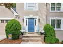 The front of the house features a blue door, chairs, and green bushes at 1405 Arden Trace Ln, Lawrenceville, GA 30043