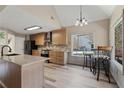 Bright kitchen with a large window, breakfast bar seating, and modern stainless steel appliances at 3850 Pilgrim Mill Rd, Cumming, GA 30041