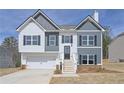 Two-story home featuring a two-car garage, covered entryway, board and batten, and shuttered windows at 500 Charleston Pl, Villa Rica, GA 30180