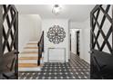 Inviting foyer featuring decorative doors, a staircase, and decorative tile flooring at 650 Hunterhill Ct, Roswell, GA 30075