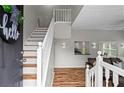 Welcoming entryway featuring a staircase with wooden steps, white risers, and a white railing at 1923 Hamby Place Nw Dr, Acworth, GA 30102