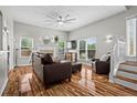 Bright living room with hardwood floors, a fireplace, lots of light and leather seating at 1923 Hamby Place Nw Dr, Acworth, GA 30102