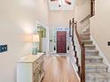 Inviting foyer with gleaming hardwood floors and a staircase leading to the upper level at 3376 Hickory Ln, Powder Springs, GA 30127