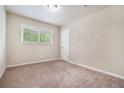 Cozy bedroom with neutral walls, plush carpet, and a bright window view at 4004 Knightsbridge Nw Rd, Kennesaw, GA 30144