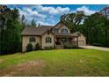Charming two-story home with a covered front porch and a well-manicured lawn at 547 Ellington Rd, Oxford, GA 30054